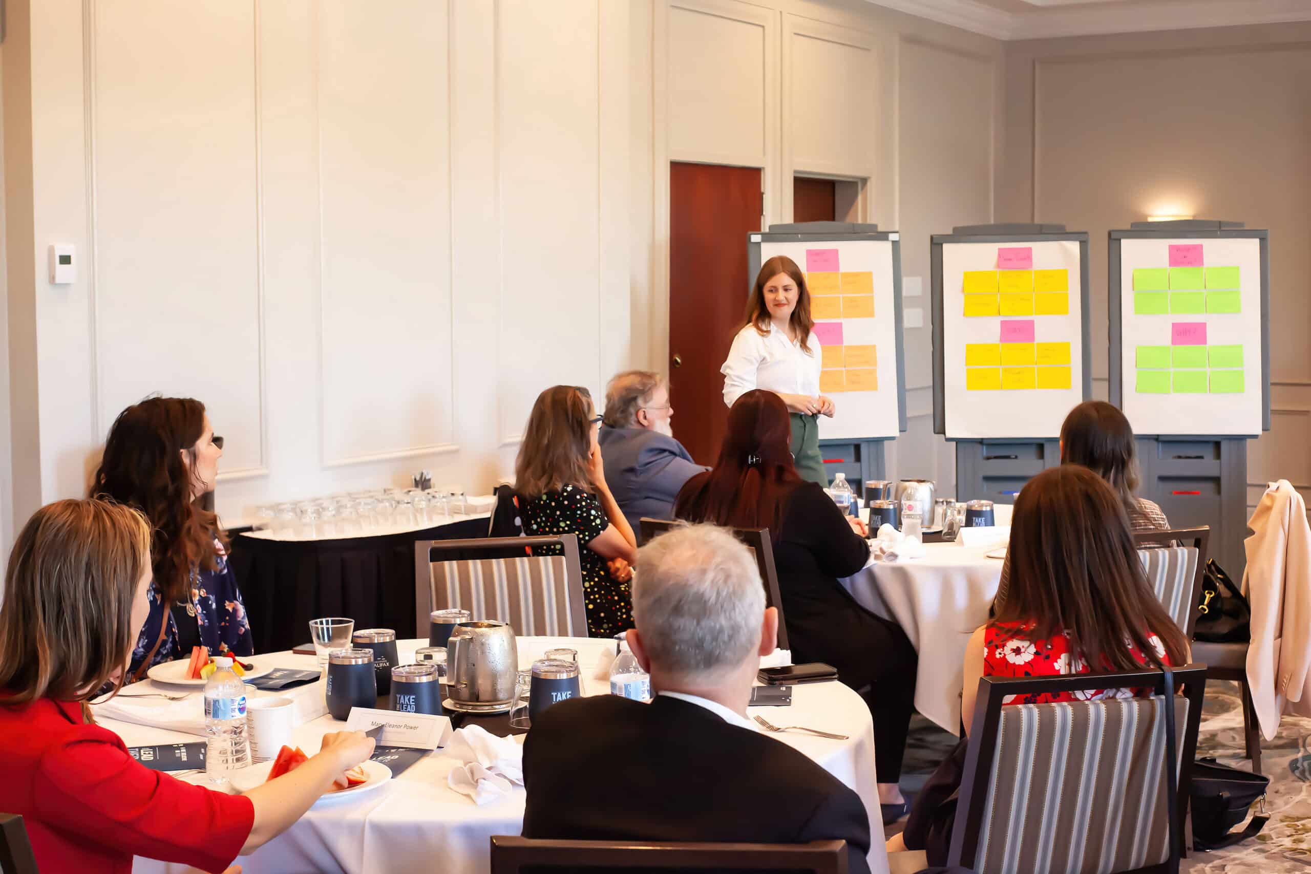 A photo of attendees listening to a presenter